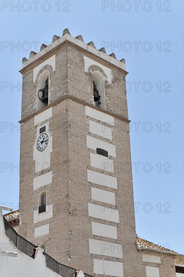 Solabrena, A tall white and brown clock tower stands proudly under a clear blue sky, Andalusia, Spain, Europe
