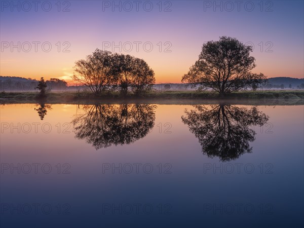 Morning atmosphere in the Saale valley near Naumburg, trees are reflected in the river Saale at dawn and ground fog, Naumburg, Saxony-Anhalt, Germany, Europe