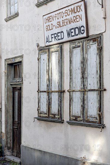 Closed shutters, abandoned photo shop with watch shop, jewellery, gold and silver, shop sign, dilapidated house, old town, Ortenberg, Vogelsberg, Wetterau, Hesse, Germany, Europe