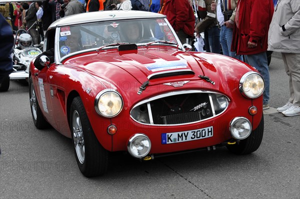A red classic sports car on a race with spectators around, SOLITUDE REVIVAL 2011, Stuttgart, Baden-Wuerttemberg, Germany, Europe