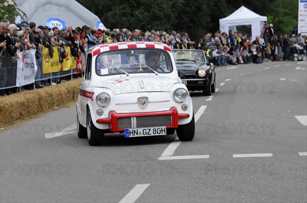 A small white and red racing car drives past a crowd of people, SOLITUDE REVIVAL 2011, Stuttgart, Baden-Wuerttemberg, Germany, Europe