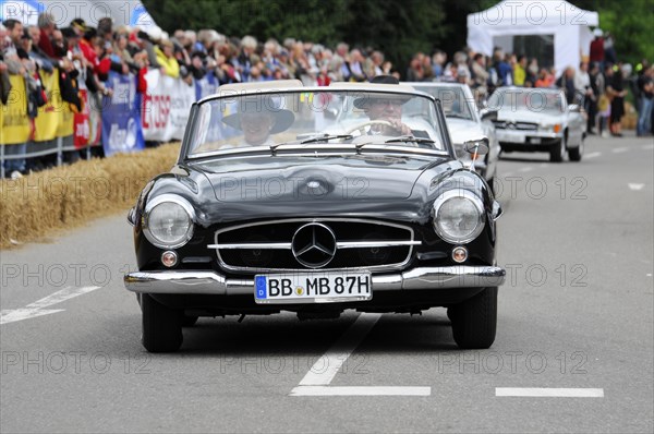 A black Mercedes-Benz convertible classic car drives on a rally surrounded by the public, SOLITUDE REVIVAL 2011, Stuttgart, Baden-Wuerttemberg, Germany, Europe