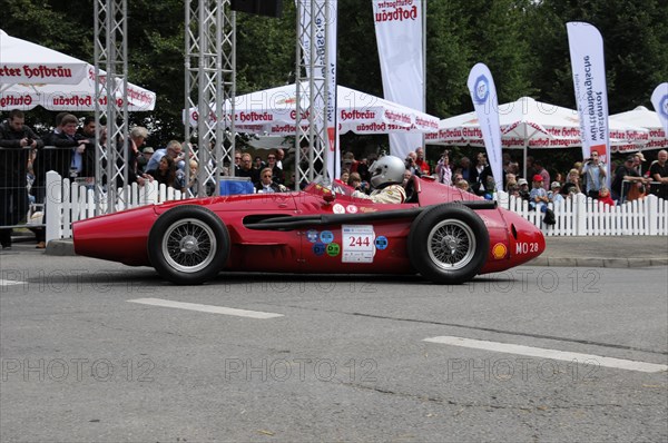Red racing car on a race track with a driver in a racing helmet, SOLITUDE REVIVAL 2011, Stuttgart, Baden-Wuerttemberg, Germany, Europe