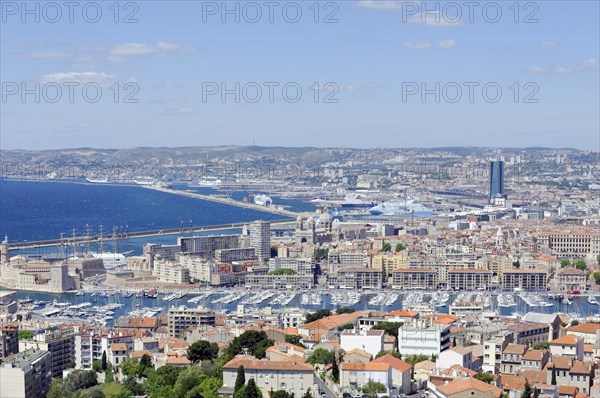 View of the busy harbour area of Marseille with city view and coastline, Marseille, Departement Bouches-du-Rhone, Region Provence-Alpes-Cote d'Azur, France, Europe