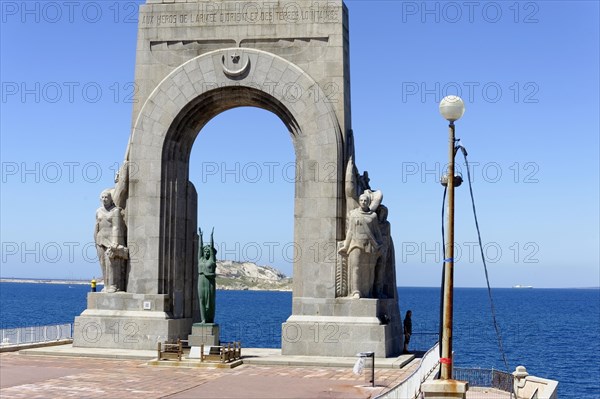 Marseille, Monumental monument with sculptures and sea in the background, Marseille, Departement Bouches-du-Rhone, Region Provence-Alpes-Cote d'Azur, France, Europe