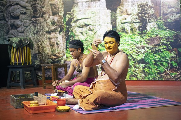 Kathakali performers or mime artists, 38 and 60 years old, make up their faces, Kochi Kathakali Centre, Kochi, Kerala, India, Asia