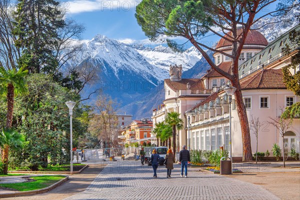 Spa promenade with spa centre in spring in front of the peak 3006m in the Texel Group, Merano, Val Passiria, Val d'Adige, Burggrafenamt, Alps, South Tyrol, Trentino-South Tyrol, Italy, Europe