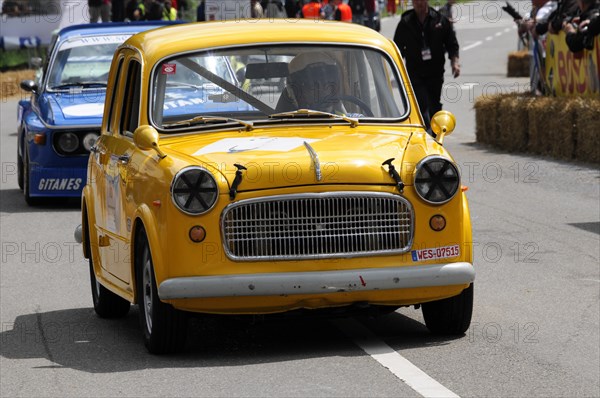 Yellow damaged vintage car with racing number and recognisable racing environment and spectators, SOLITUDE REVIVAL 2011, Stuttgart, Baden-Wuerttemberg, Germany, Europe