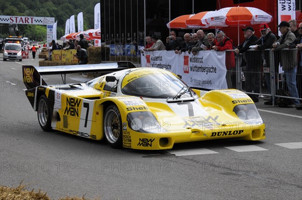 A yellow and black Porsche racing car with NEW MAN branding on a race track, SOLITUDE REVIVAL 2011, Stuttgart, Baden-Wuerttemberg, Germany, Europe