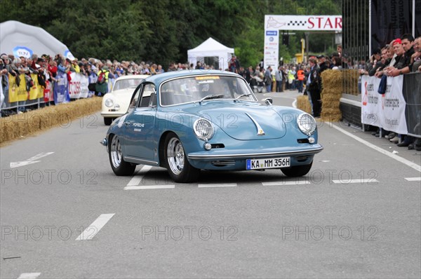 A blue old sports car accelerates on a race track with a crowd in the background, SOLITUDE REVIVAL 2011, Stuttgart, Baden-Wuerttemberg, Germany, Europe