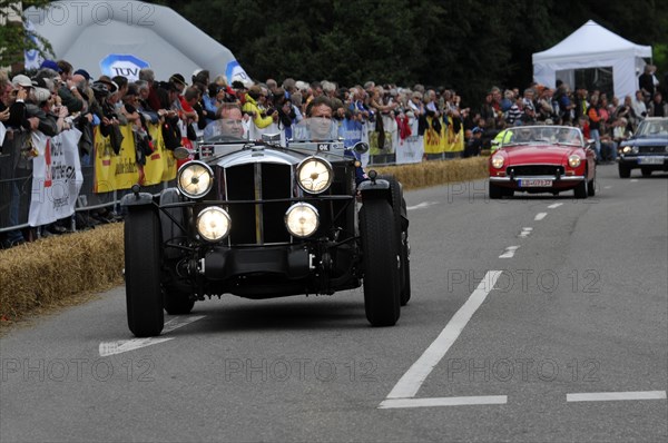 A vintage car with illuminated headlights at a classic car race, SOLITUDE REVIVAL 2011, Stuttgart, Baden-Wuerttemberg, Germany, Europe