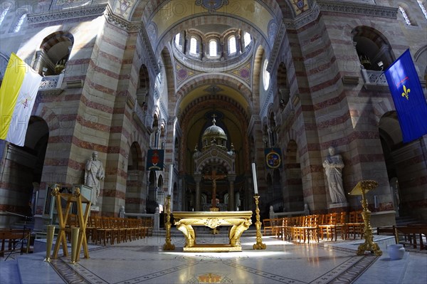 Marseille Cathedral or Cathedrale Sainte-Marie-Majeure de Marseille, 1852-1896, Marseille, Interior view of a church with a view of the altar and stained glass windows above pews, Marseille, Departement Bouches-du-Rhone, Region Provence-Alpes-Cote d'Azur, France, Europe