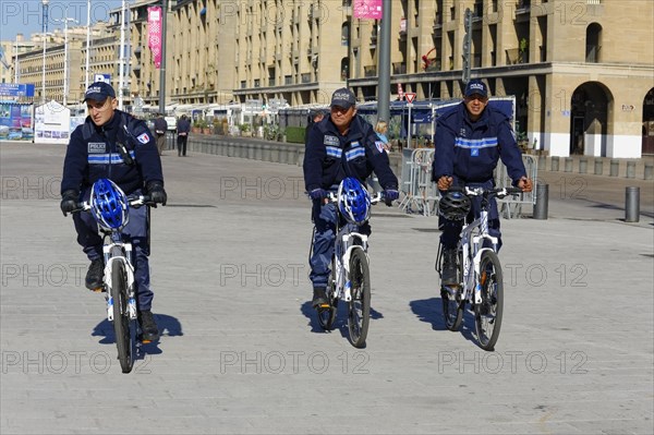 Three police officers on bicycles patrolling a city street, Marseille, Bouches-du-Rhone department, Provence-Alpes-Cote d'Azur region, France, Europe