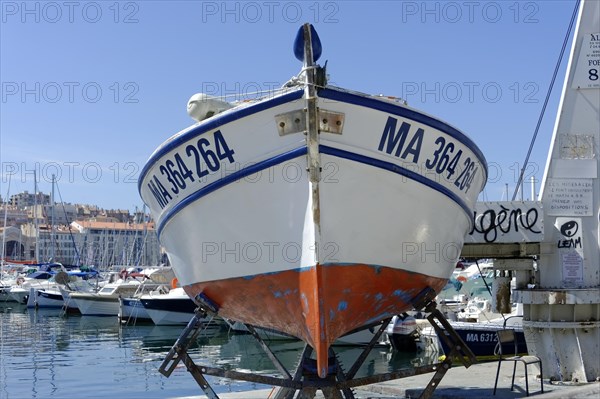 Marseille harbour, A boat in dry dock with a view of the harbour in the background, Marseille, Departement Bouches-du-Rhone, Region Provence-Alpes-Cote d'Azur, France, Europe