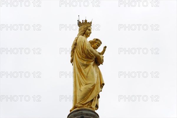 Madonna, Church of Notre-Dame de la Garde, Marseille, A golden statue of Mary with the child Jesus in front of a cloudy sky, Marseille, Departement Bouches-du-Rhone, Region Provence-Alpes-Cote d'Azur, France, Europe