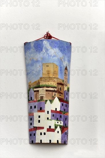 Solabrena, Colourful hanging painting of a city view on a white wall, Costa del Sol, Andalusia, Spain, Europe
