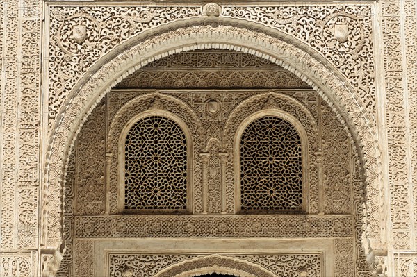 Artistic stone carvings, Alhambra, Granada, An intricately decorated window with arabesques in a historic building, Granada, Andalusia, Spain, Europe