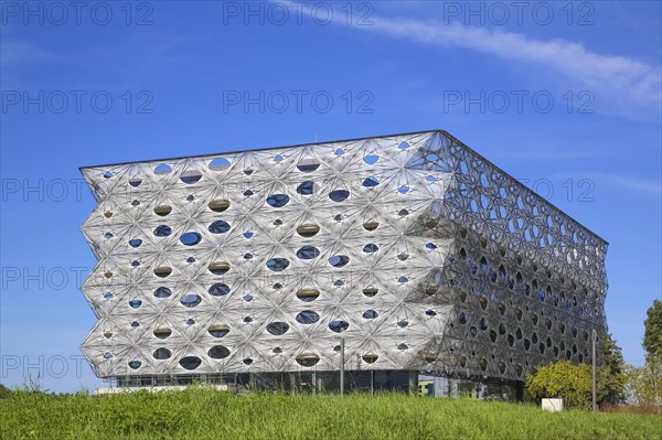 Reutlingen University, Reutlingen University, Texoversum, German University Building Award 2024 for TEXOVERSUM, modern architecture, facade made of carbon and glass fibres, mesh, innovative, identity-creating, unique facade, campus, place of learning, special, extraordinary new building for textile courses, light, airy, airy, holes, architectural eye-catcher, green meadow, university campus, Reutlingen, Baden-Wuerttemberg, Germany, Europe