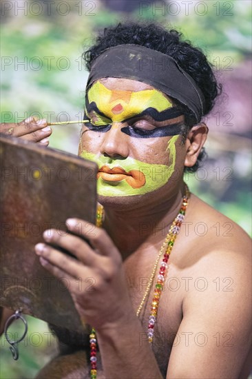 Kathakali performer or mime, 38 years old, makes up his face, Kochi Kathakali Centre, Kochi, Kerala, India, Asia
