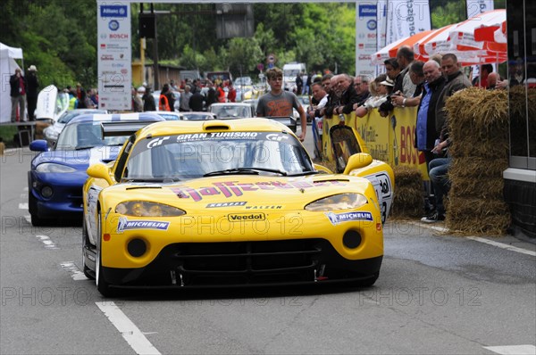 A yellow racing car with a racing driver at a sporting event, surrounded by spectators, SOLITUDE REVIVAL 2011, Stuttgart, Baden-Wuerttemberg, Germany, Europe