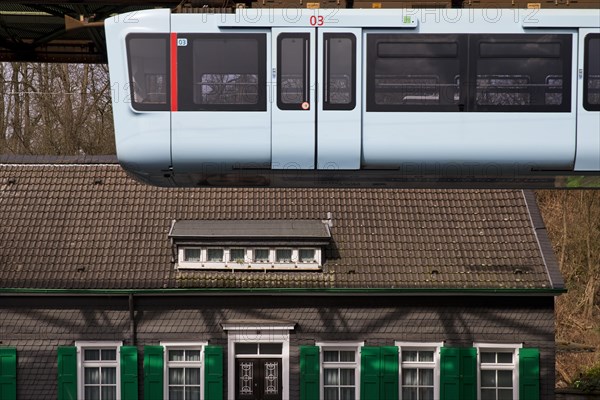 New suspension railway in front of a traditional Bergisch house in Vohwinkel, Wuppertal, Bergisches Land, North Rhine-Westphalia, Germany, Europe