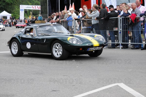 A green and yellow vintage sports car takes part in a road rally in front of an audience, SOLITUDE REVIVAL 2011, Stuttgart, Baden-Wuerttemberg, Germany, Europe