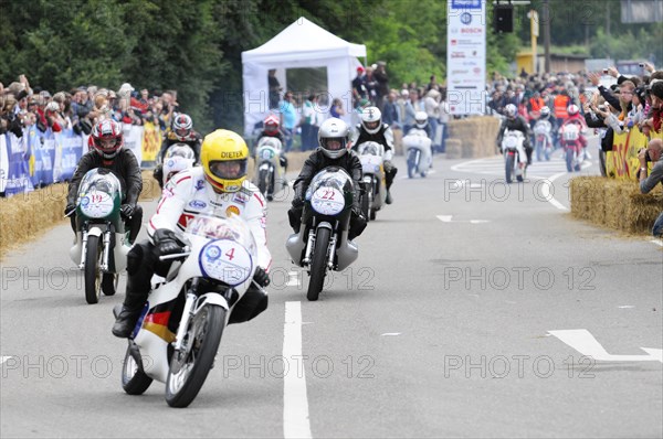 A group of motorcyclists during a race, surrounded by spectators, SOLITUDE REVIVAL 2011, Stuttgart, Baden-Wuerttemberg, Germany, Europe