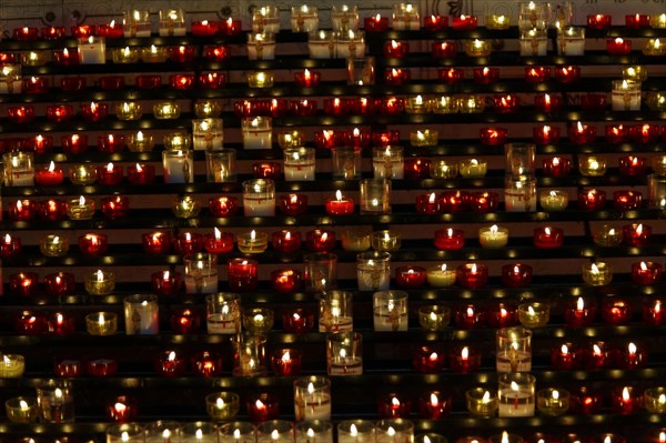 Church of Notre-Dame de la Garde with mosaics, Marseille, Many lit candles arranged in rows create a devotional atmosphere, Marseille, Departement Bouches-du-Rhone, Region Provence-Alpes-Cote d'Azur, France, Europe