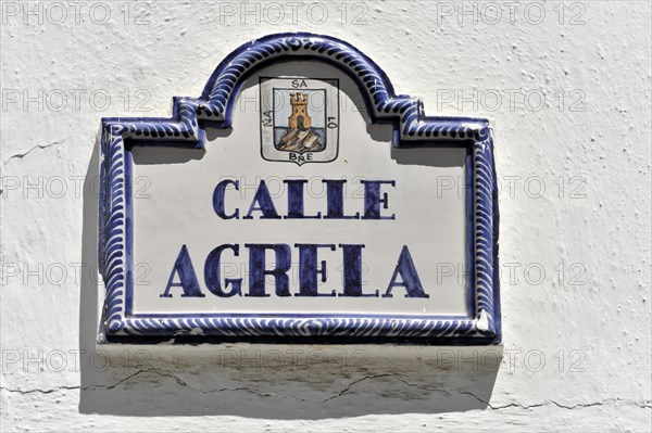 Solabrena, ceramic street sign with blue ornaments and heraldic coat of arms on a white wall, Costa del Sol, Andalusia, Spain, Europe