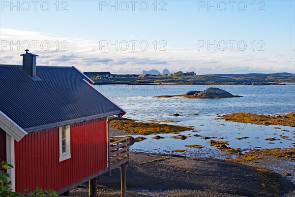 Red building with balcony by the water, Rorbuer, holiday, accommodation, Lovund, Lovunden, Helgeland coast, Norway, Europe