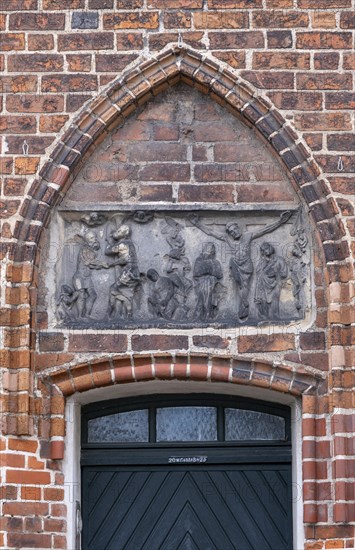 Relief with crucified Christ above a door of the parish church of St Laurentius, Havelberg, Saxony-Anhalt, Germany, Europe
