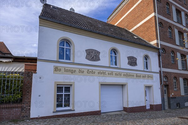 House with inscription: As long as the earth stands, sowing and harvesting shall not cease, Havelberg, Saxony-Anhalt, Germany, Europe