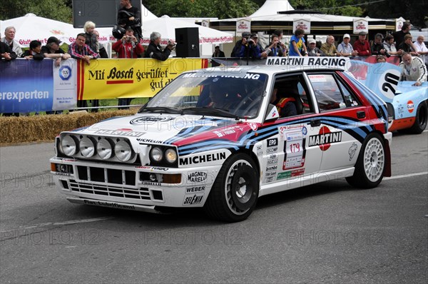 A Lancia rally car with Martini Racing stickers drives past spectators on a road, SOLITUDE REVIVAL 2011, Stuttgart, Baden-Wuerttemberg, Germany, Europe