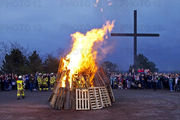 The fire brigade has lit the Easter bonfire on the Haniel spoil tip in front of the summit cross, Bottrop, Ruhr area, North Rhine-Westphalia, Germany, Europe