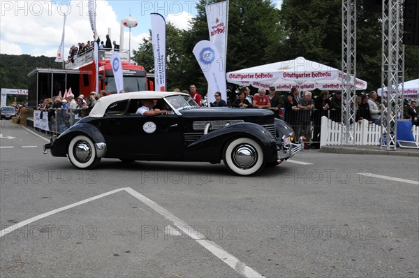Black classic car takes part in a classic car rally, surrounded by spectators, SOLITUDE REVIVAL 2011, Stuttgart, Baden-Wuerttemberg, Germany, Europe
