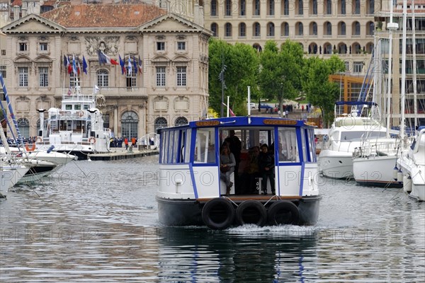 Marseille harbour, A small ferry with passengers crosses the harbour water, Marseille, Departement Bouches-du-Rhone, Region Provence-Alpes-Cote d'Azur, France, Europe