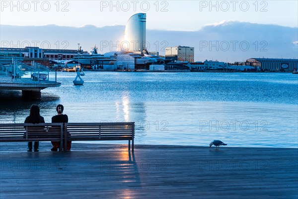 Two people sitting at the old harbour in Barcelona, Spain, Europe