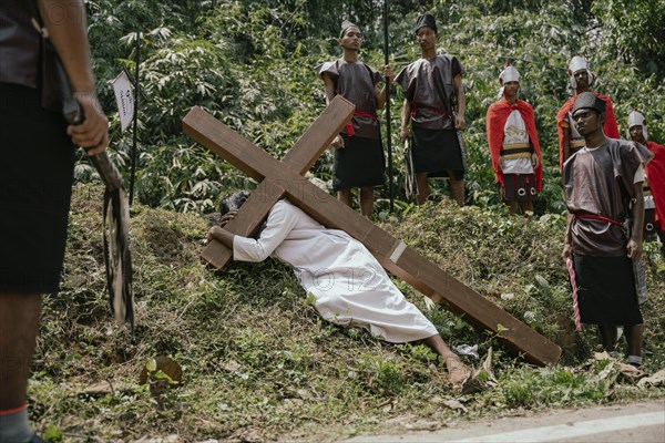 Christian devotees takes part in a perform to re-enactment of the crucifixion of Jesus Christ during a procession on Good Friday, on March 29, 2024 in Guwahati, Assam, India. Good Friday is a Christian holiday commemorating the crucifixion of Jesus Christ and his death at Calvary