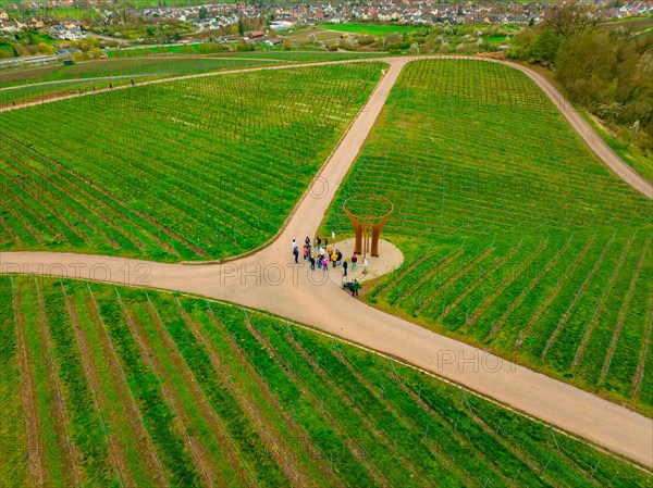 People gather around a round building in a sprawling vineyard, Jesus Grace Chruch, Weitblickweg, Easter hike, Hohenhaslach, Germany, Europe