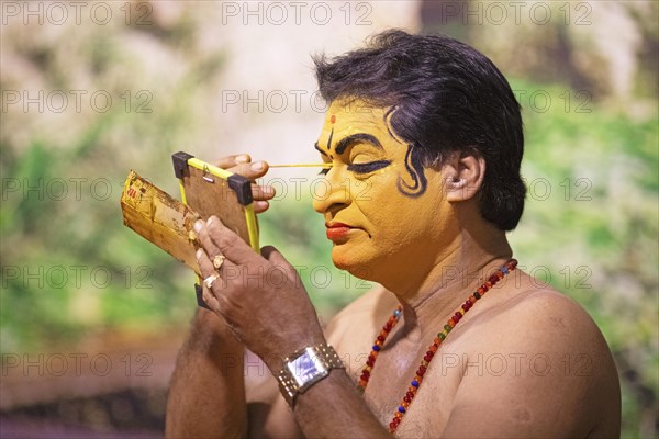 Kathakali performer or mime, 60 years old, makes up his face, Kochi Kathakali Centre, Kochi, Kerala, India, Asia