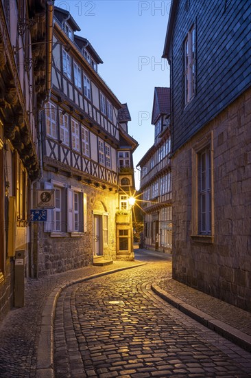 Narrow alley with half-timbered houses and cobblestones at Finkenherd in the historic old town at dusk, UNESCO World Heritage Site, Quedlinburg, Saxony-Anhalt, Germany, Europe