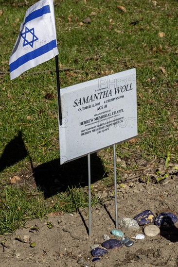 Ferndale, Michigan, An Israeli flag and small stones on the grave of Samantha Woll in Machpelah Cemetery. Woll was stabbed to death outside her Detroit home in October 2023. She was president of Isaac Agree Downtown Synagogue, but police ruled out anti-semitism as a motive in the crime. Woll was the founder of the Muslim-Jewish Forum of Detroit