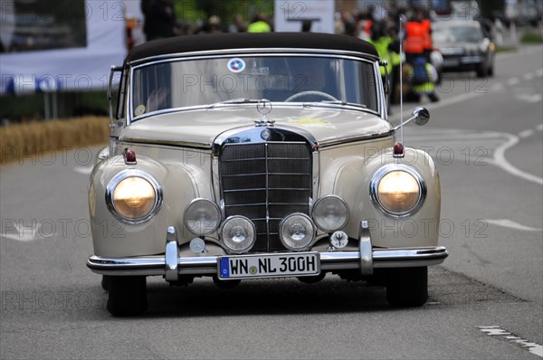 A white Mercedes-Benz classic car drives on a road during a rally, SOLITUDE REVIVAL 2011, Stuttgart, Baden-Wuerttemberg, Germany, Europe