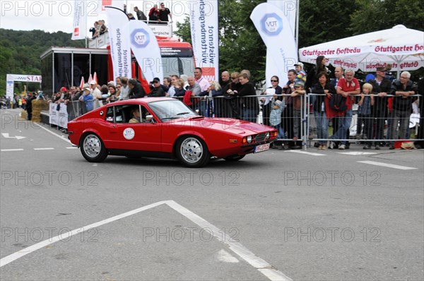 A red old sports car drives on a race track, applauded by a crowd, SOLITUDE REVIVAL 2011, Stuttgart, Baden-Wuerttemberg, Germany, Europe