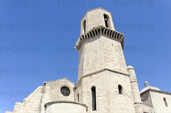 Marseille, Historic church under a clear blue sky with a massive stone tower, Marseille, Departement Bouches-du-Rhone, Provence-Alpes-Cote d'Azur region, France, Europe