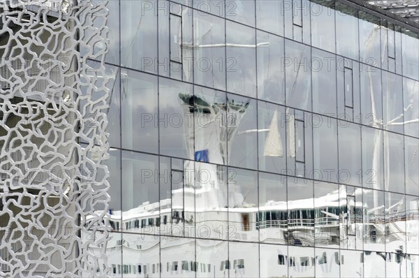 Marseille, Reflection of a sailing ship in the windows of a building with a modern, unusual facade, Marseille, Departement Bouches-du-Rhone, Provence-Alpes-Cote d'Azur region, France, Europe