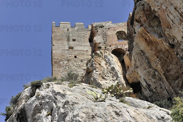 Solabrena, view upwards to an old fortress with stone walls and gates on rocky ground, Costa del Sol, Andalusia, Spain, Europe