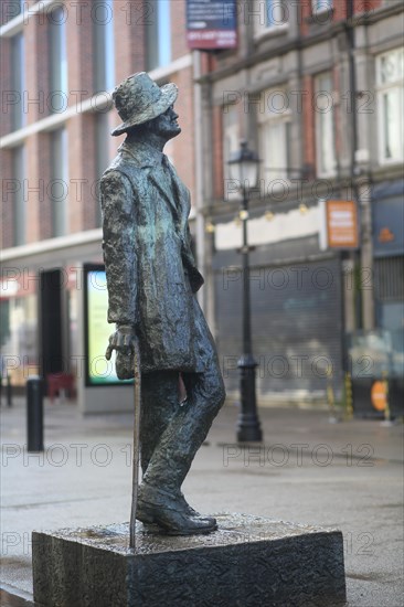 A statue to James Joyce, the famous Irish writer and creator of the book Ulysses, by artist Marjorie Fitzgibbon on a grey day. Dublin, Ireland, Europe