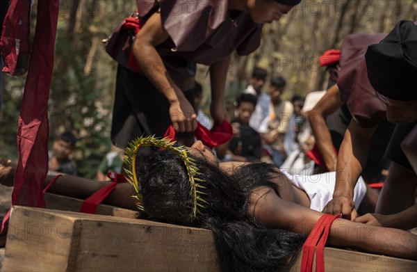 Christian devotees takes part in a perform to re-enactment of the crucifixion of Jesus Christ during a procession on Good Friday, on March 29, 2024 in Guwahati, Assam, India. Good Friday is a Christian holiday commemorating the crucifixion of Jesus Christ and his death at Calvary