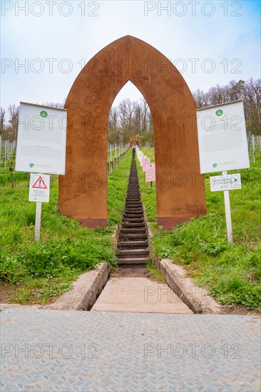 A rust-coloured metal gate marks the entrance to a staircase leading through a vineyard, Jesus Grace Chruch, Weitblickweg, Easter hike, Hohenhaslach, Germany, Europe
